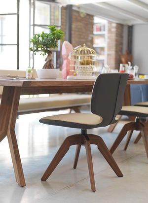 aye chair in two colours of leather with swivel base in walnut