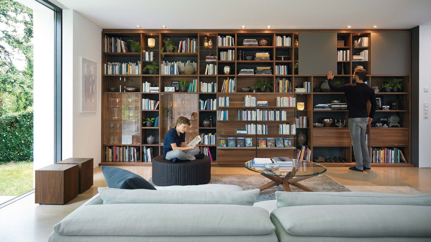 cubus library in walnut integrated into the cubus wall unit