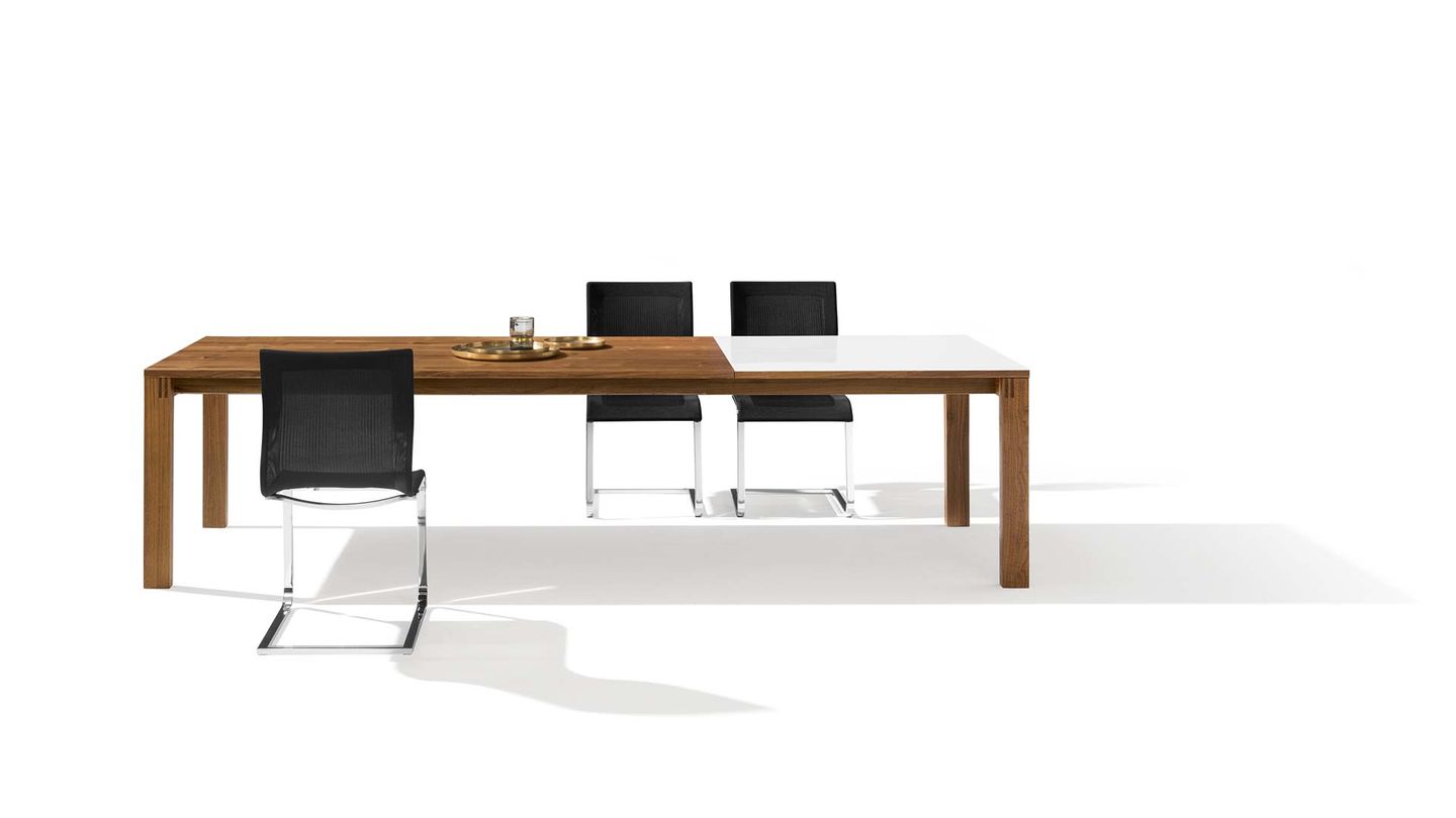 Magnum extendable table with magnum Stricktex cantilever chairs by TEAM 7