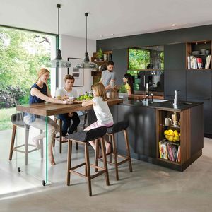 black line kitchen with add-on table in walnut by TEAM 7.